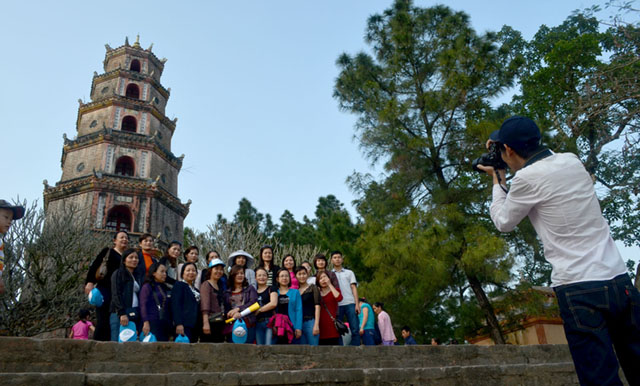 Tourists pose for a photo in front of Thien Mu pagoda in Hue City, Vietnam. MindaNews photo by Lorie Ann Cascaro