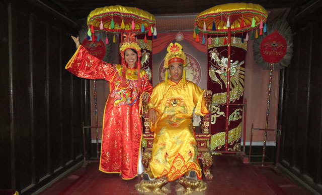 Authors Lorie and Jesse dress up as Vietnamese royalty in an old room in Tu Duc Tomb. MindaNews photo